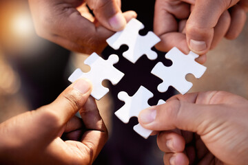 Group hands with puzzle for solution, teamwork and workflow goals, achievement and success in closeup. Team building game, project development and people for problem solving, synergy or collaboration - obrazy, fototapety, plakaty