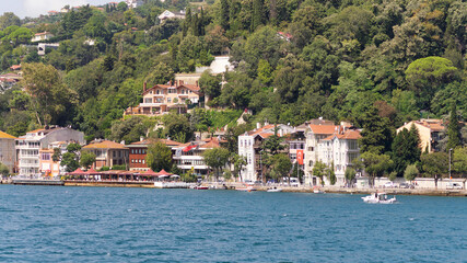 Fototapeta na wymiar View from the sea of the European side of Bosphorus strait, Istanbul, Turkey, with traditional houses, in a summer day
