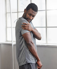 Shoulder injury, black man and pain in gym from exercise, medical emergency and injured muscle, bruise or joint. Male, arm and fitness accident from workout, first aid and health risk in sports club