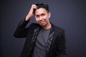 Asian male in corporate oufit over dark background.  Office business concept.