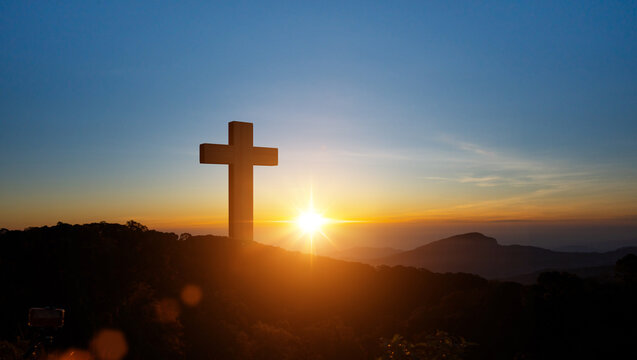Silhouettes of Christian cross symbol on top mountain at sunrise sky background. Concept of Crucifixion Of Jesus Christ.