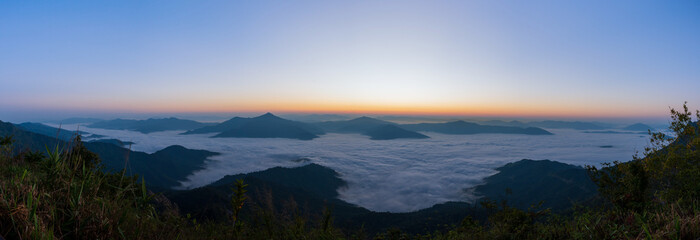 Beautiful landscape on the mountains at sunrise. Spectacular view in foggy valley covered forest under morning sky. Panorama Picture