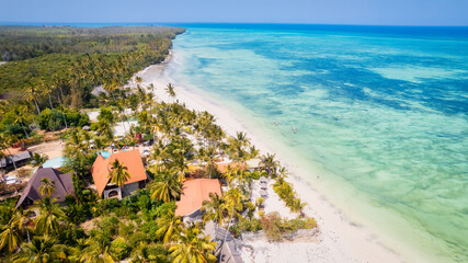 The Indian Ocean beach in Zanzibar, Africa, is a breathtaking sight from above. The sandy shore is...