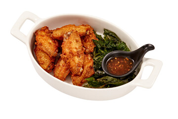 Crispy Fried Chicken wings with Crispy Basil Leaves and Chicken dipping sauce (sweet) isolated on white background. popular appetizers.