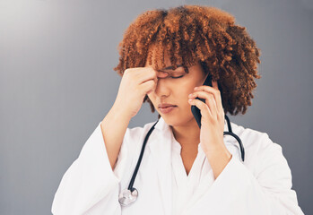 Woman doctor on phone call stress, headache or anxiety for healthcare problem isolated on gray...