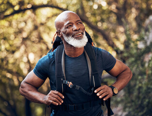 Nature, backpack and senior black man hiking in a forest for exercise, health and wellness. Sports,...