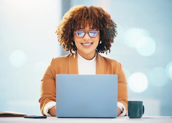 Business, black woman and laptop with glasses reading or typing email online in office. Entrepreneur person smile at desk with technology and bokeh mockup space for career research and data analysis