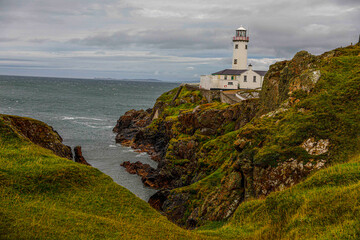 Fototapeta na wymiar Lighthouse along coast in Ireland