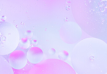 Abstract background in blue and violet soft tones. Macro drops of oil on the surface of the water. Delicate cosmetic background for advertising products. copy space.