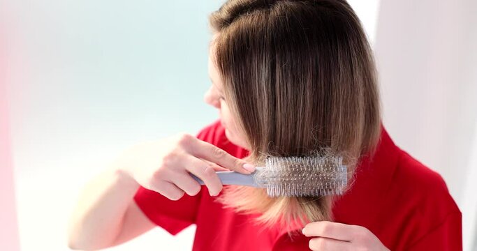 Woman combing her hair and hair loss concept