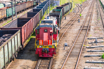 Shunting diesel locomotive and railway wagons. Railway wagons at the station for the transportation...