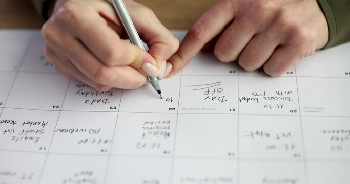 Manager and seo writes calendar for planning affairs and meetings