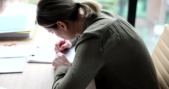 Young woman works in office with crooked back