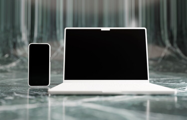 Matte white mockup laptop and smartphone. Green granite studio setting.