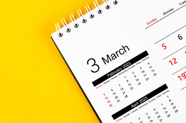 Close up the March 2023 Monthly desk calendar for 2023 year on yellow background.