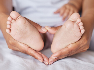 Closeup, feet and baby with mother, hands and care for kid, support and touch for bonding and playful. Zoom, mama and infant with health, wellness and newborn with female parent or child development