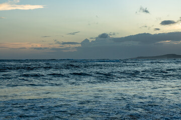 Fototapeta na wymiar Watching the sunset at Poipu Beach in Kauai, Hawaii