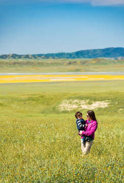 Mother holding child at&Acirc;&nbsp;Carrizo&Acirc;&nbsp;Plain National Monument, California, USA