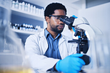 Microscope, science and black man working on study in laboratory for medical research analysis....