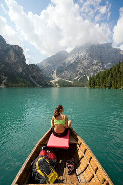 Woman relaxing in a row boat in the Italian Dolomites