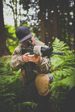 A soldier takes aim with his gun.