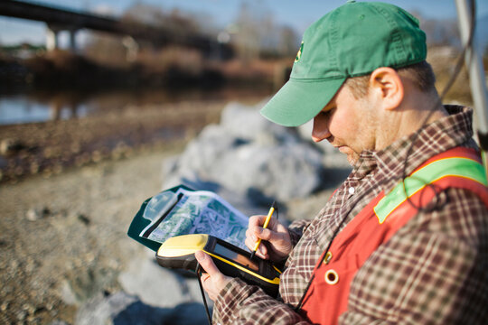 A Field Technician Collects Data With A GPS Unit.