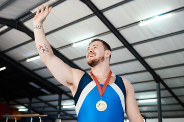 Man, medal celebration and winning smile with wave, sports and hand in air at competition with...