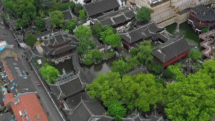 Aerial Panning Shot Of Ancient Houses In Famous Extensive Chinese Garden While People Exploring On Vacation - Shanghai, China