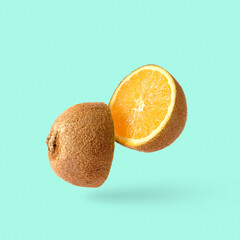 Cut kiwi fruit and inside an orange. Joke minimal pop art surprise fun poster. High quality photo