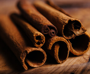 Cinnamon sticks on wooden background close-up