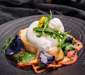 Buffalo burrata cheese served with grain toast pasting and fresh vegetables