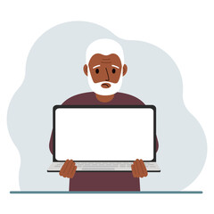The man is holding a laptop with the screen facing away from him. On the screen of the laptop there is a place for text. Laptop computer technology concept, online education, online work.