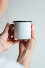 Close-up of an enameled mug in hand