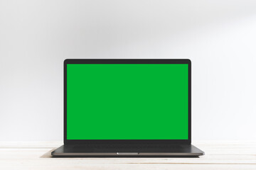 Chroma key green screen laptop on table with white background