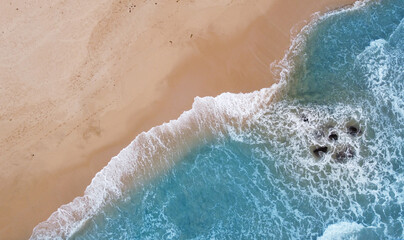 Aerial view of the ocean coast and sandy sea beach. Beautiful water background texture for tourism and advertising. Tropical coast