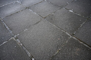asphalt soviet square concrete tile, asphalt tile covered with thin ice crust, icy ice tile,...