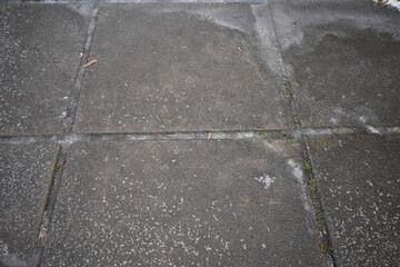 asphalt soviet square concrete tile, asphalt tile covered with thin ice crust, icy ice tile,...