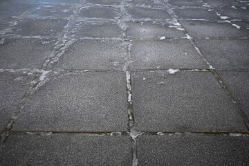 asphalt soviet square concrete tile, asphalt tile covered with thin ice crust, icy ice tile,...