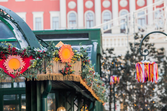 Moscow seasons. Decorations on Tverskaya Street in honor of the celebration of the traditional Russian holiday Maslenitsa. The image of the Sun and multicolored ribbons on street lamps.