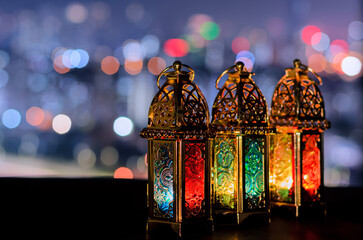 Lanterns with night sky and city bokeh light background for the Muslim feast of the holy month of...