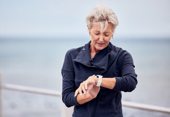 Smart watch, senior woman and fitness outdoor at beach promenade, exercise or sky mockup....