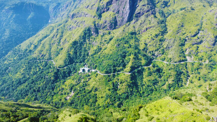 Aerial view of the green hills and gorge. Beautiful mountain background texture for tourism and advertising. Tropical landscape from a drone