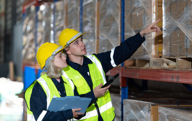 Both of employees in an auto parts warehouse, Examine auto parts that are ready to be shipped to the automobile assembly factory.