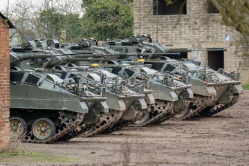 a row of five British army Warrior FV510 fighting vehicles ready for military deployment, Wilts UK