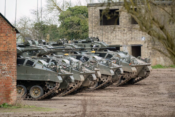 a row of British army Warrior FV510 tanks ready for military deployment, Wilts UK