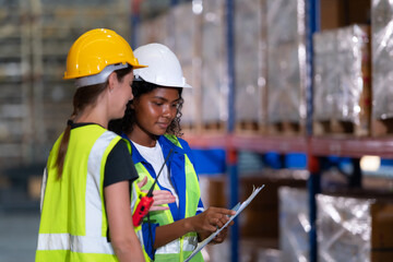 Both of employees in an auto parts warehouse, Examine auto parts that are ready to be shipped to the automobile assembly factory.
