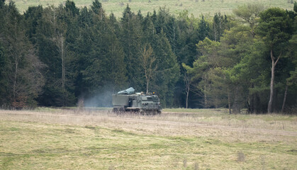 Obraz premium British army self propelled M270 Multiple Launch Rocket System (MLRS) tank unit training Ukranian crew on a military exercise, Wiltshire UK