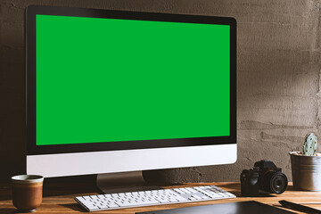 Chroma key green screen, angled view computer on table with digital photography equipment