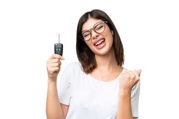 Young Russian woman holding car keys over isolated chroma key background celebrating a victory