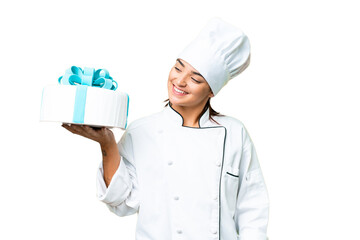 Woman pastry chef with a big cake with happy expression